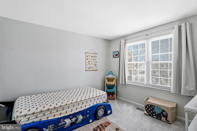 bedroom with carpet and baseboards