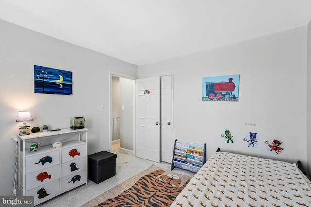 bedroom with a closet and light carpet