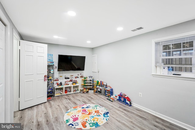 playroom with recessed lighting, wood finished floors, visible vents, and baseboards