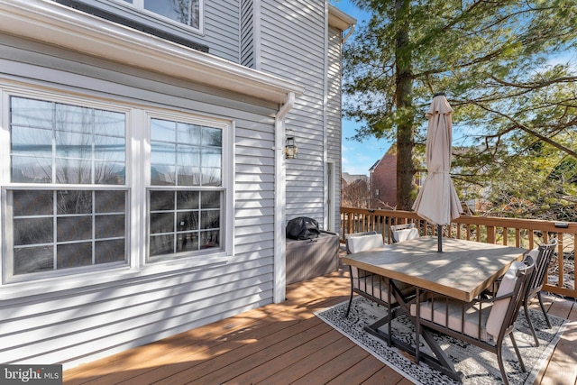 wooden terrace featuring outdoor dining area