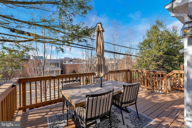 wooden terrace with outdoor dining area