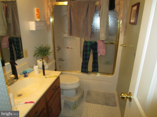 bathroom with tile patterned flooring, shower / bath combination with glass door, vanity, and toilet