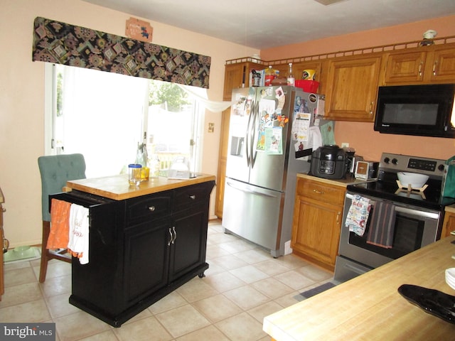 kitchen featuring stainless steel appliances, dark cabinetry, and brown cabinets