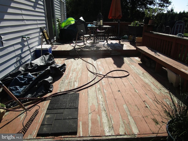 wooden terrace featuring outdoor dining area