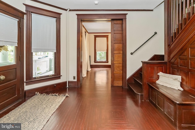 interior space with ornamental molding, parquet floors, stairway, and baseboards