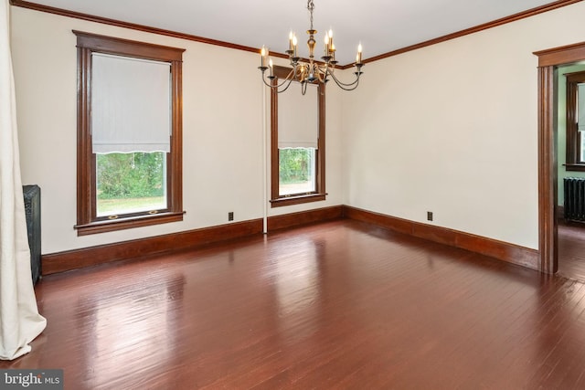 empty room featuring crown molding, baseboards, dark wood-style floors, and radiator