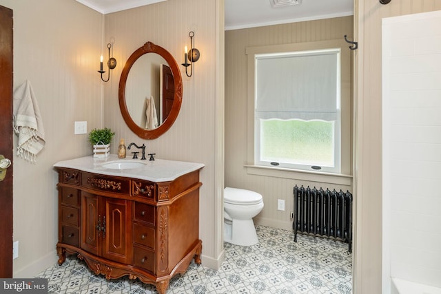 bathroom featuring toilet, vanity, baseboards, ornamental molding, and radiator heating unit