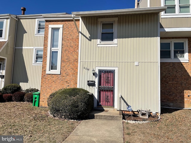 property entrance featuring brick siding