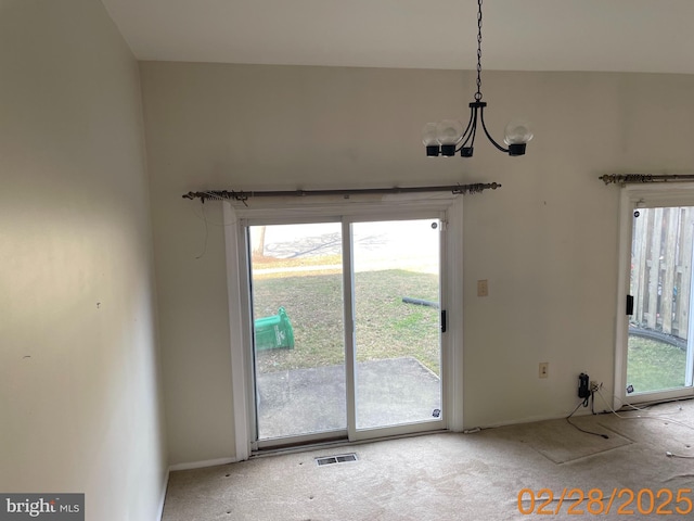 doorway with a chandelier and visible vents