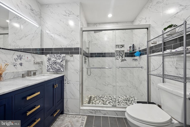 bathroom featuring tile walls, recessed lighting, toilet, a stall shower, and vanity