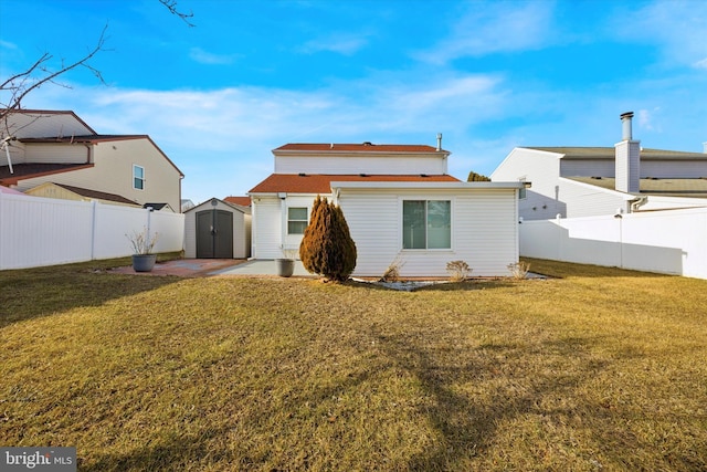 back of property with a fenced backyard, a patio, and a yard