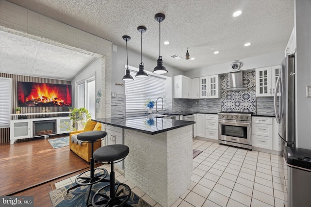 kitchen featuring glass insert cabinets, dark countertops, white cabinets, and stainless steel appliances