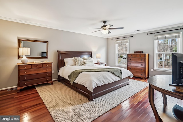 bedroom featuring dark wood-style flooring, visible vents, and multiple windows