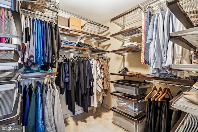 spacious closet with tile patterned floors