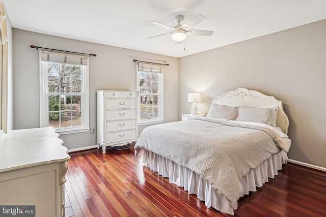 bedroom featuring a ceiling fan, baseboards, and wood finished floors