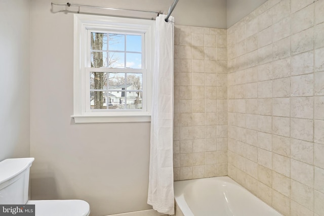 bathroom with toilet and shower / bathtub combination with curtain