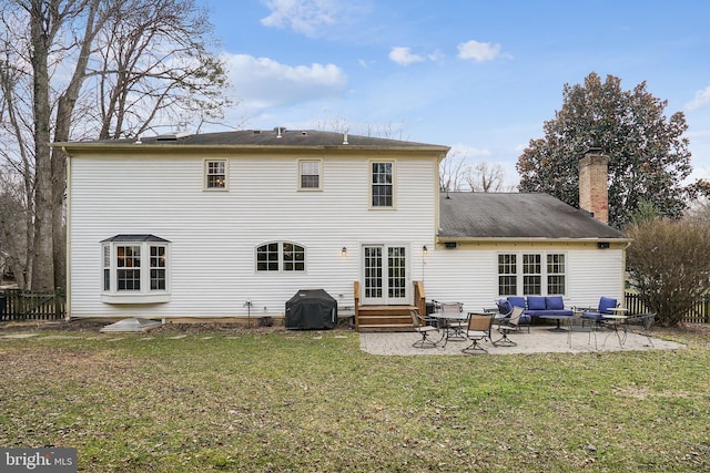 back of property featuring a patio area, fence, outdoor lounge area, and a lawn