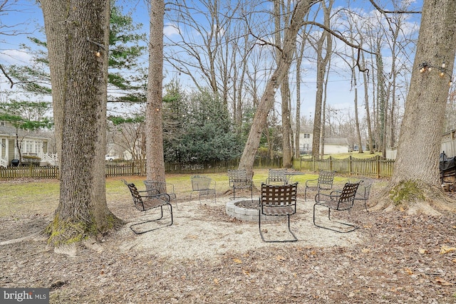 view of yard featuring a fire pit and fence