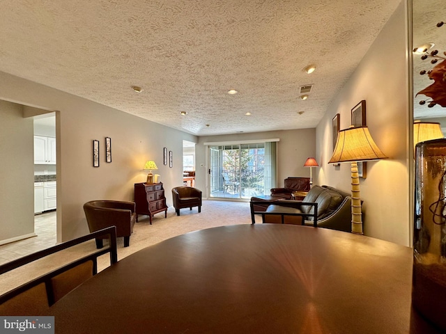 dining area featuring a textured ceiling, recessed lighting, light carpet, visible vents, and baseboards