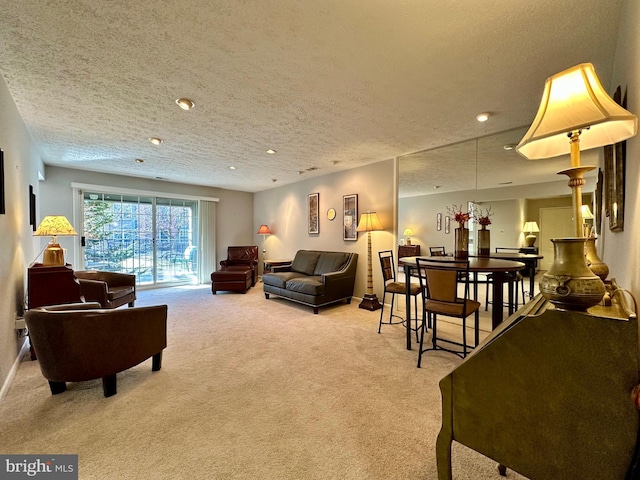 living area with recessed lighting, light colored carpet, a textured ceiling, and baseboards