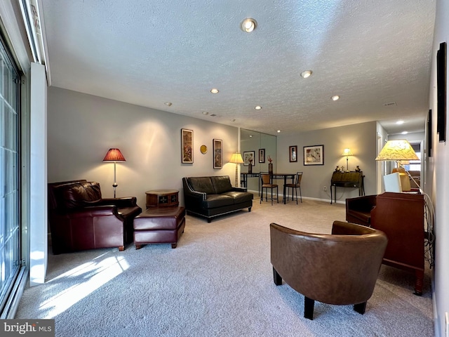 carpeted living room with a textured ceiling, baseboards, and recessed lighting