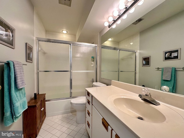 bathroom featuring toilet, visible vents, combined bath / shower with glass door, and tile patterned floors