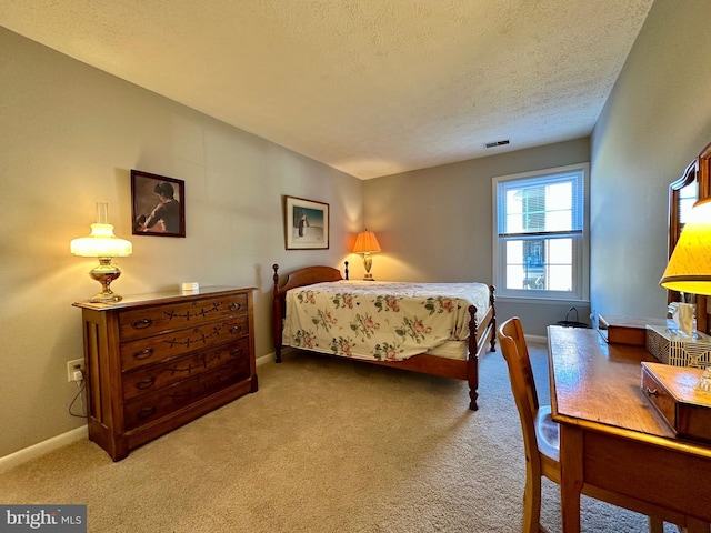 bedroom featuring a textured ceiling, carpet floors, visible vents, and baseboards