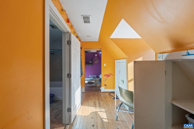 interior space with light wood-style floors and visible vents