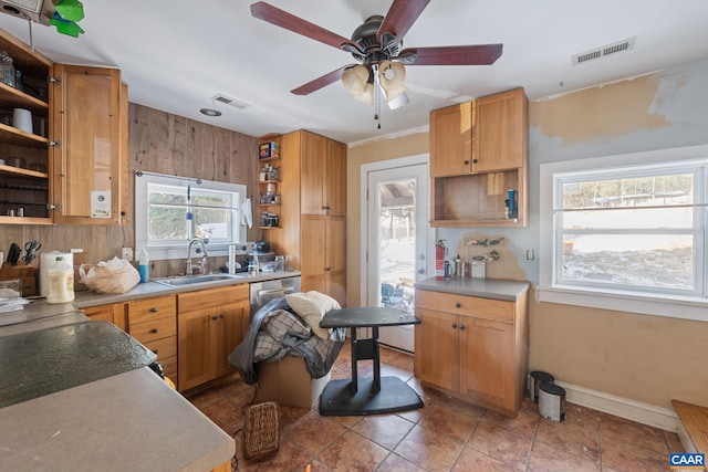 kitchen with light countertops, a sink, visible vents, and open shelves