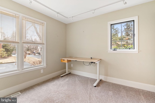 office featuring rail lighting, light colored carpet, visible vents, and baseboards