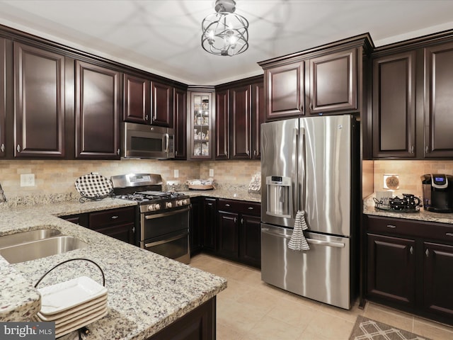 kitchen with stainless steel appliances, decorative backsplash, and dark brown cabinets