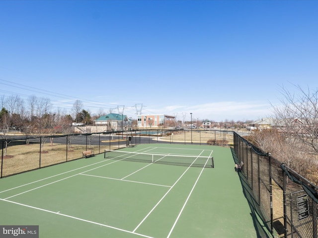 view of sport court featuring fence