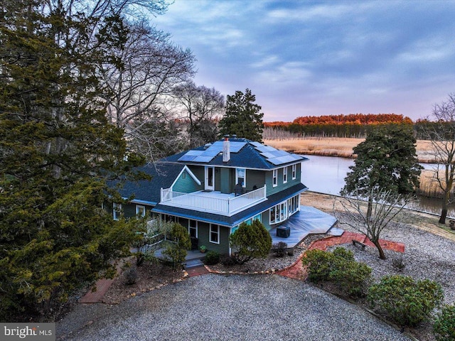 view of front of property featuring driveway and solar panels