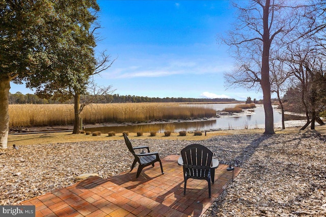 view of patio featuring a water view