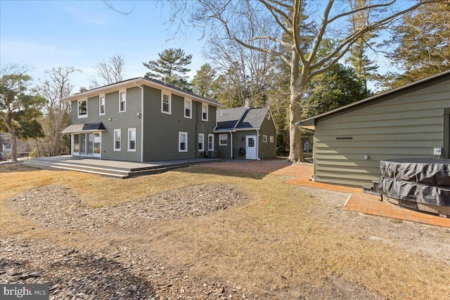 back of house featuring a deck