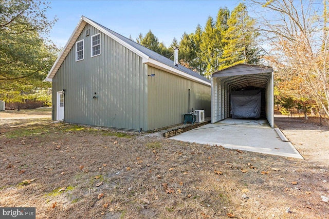 exterior space featuring a detached carport and dirt driveway