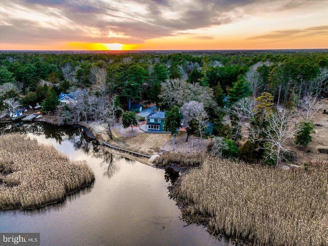 aerial view at dusk with a water view