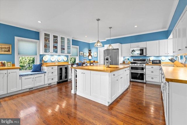 kitchen with white cabinetry, appliances with stainless steel finishes, light countertops, and a sink