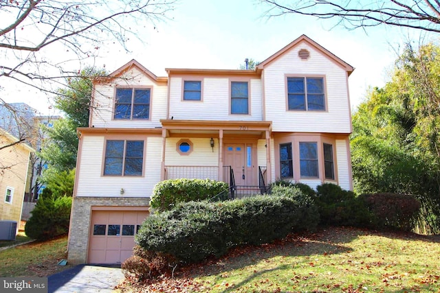 view of front of property with an attached garage, covered porch, driveway, and brick siding