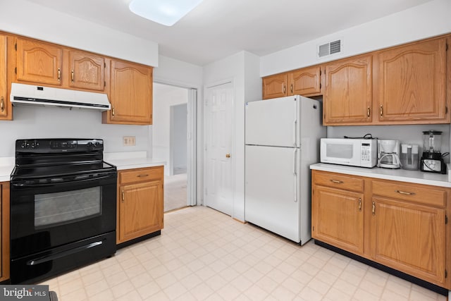 kitchen with white appliances, visible vents, extractor fan, light countertops, and light floors