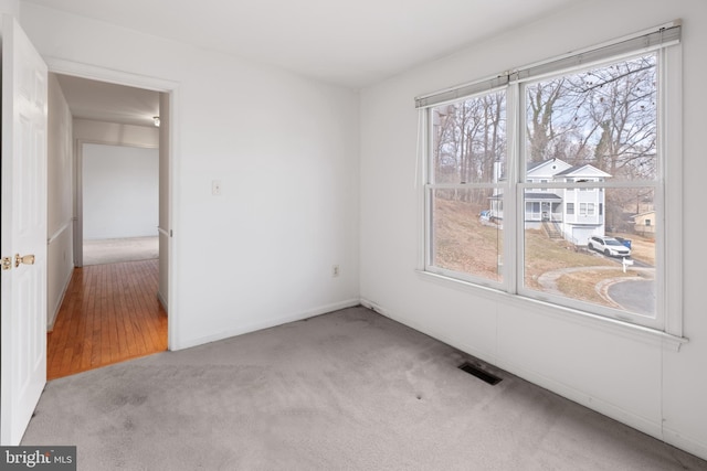 empty room with carpet and visible vents