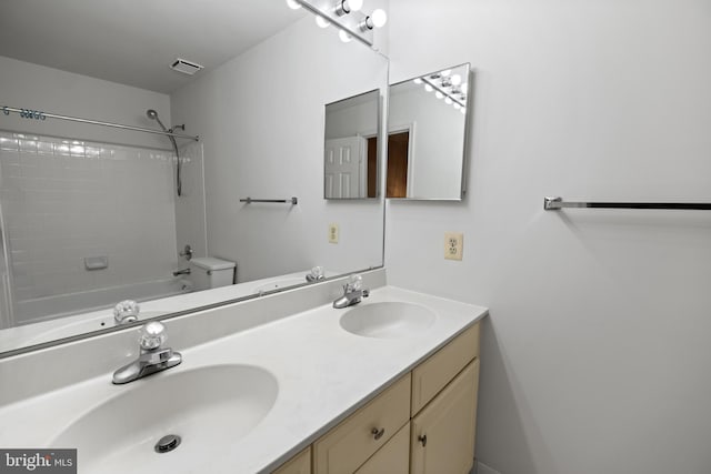 full bath featuring visible vents, a sink, toilet, and double vanity