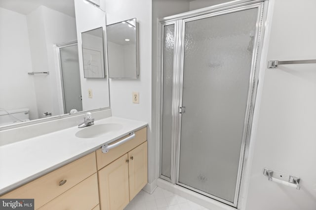 full bathroom featuring toilet, a shower stall, and vanity