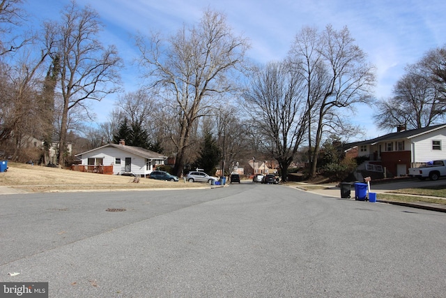 view of road with curbs, sidewalks, and a residential view