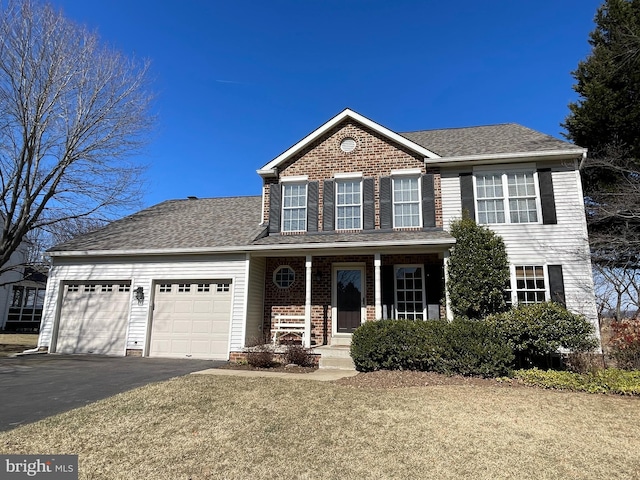 view of front of home featuring brick siding, a porch, a shingled roof, an attached garage, and driveway