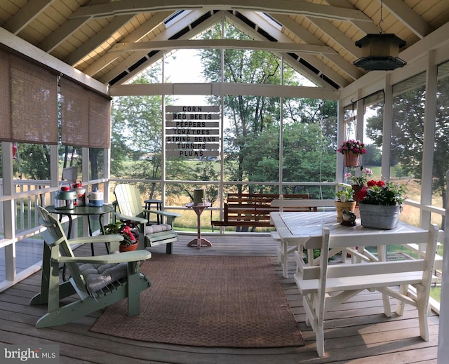 sunroom with vaulted ceiling with beams, wood ceiling, and a healthy amount of sunlight