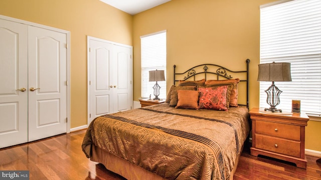 bedroom featuring wood finished floors and baseboards