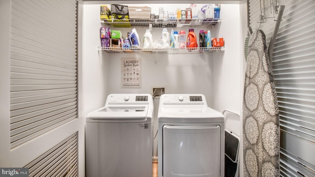 clothes washing area with laundry area and independent washer and dryer