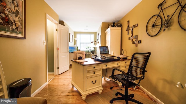 home office featuring light wood-style floors and baseboards