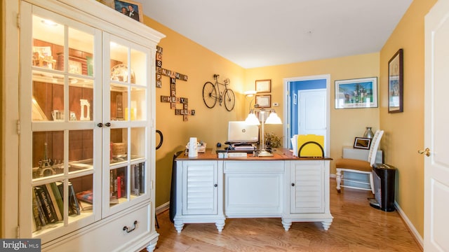 office featuring light wood-style flooring and baseboards